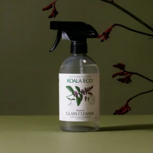 Koala Eco Natural Glass Cleaner with Australian Peppermint Essential Oil in a 500ml spray bottle against a sage green background with red botanical branches